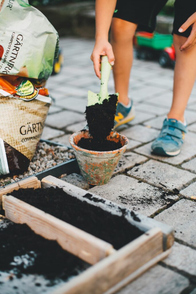 A man filling soil into a port